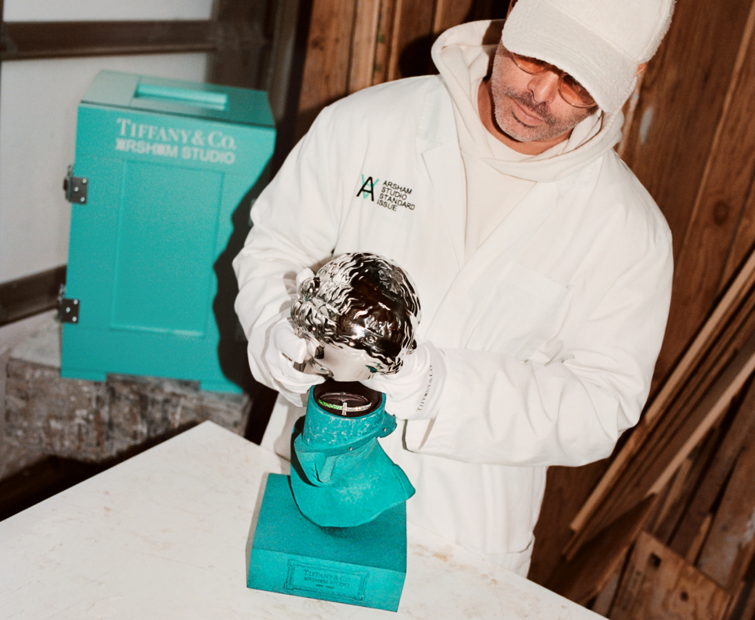 Daniel Arsham with the Tiffany & Arsham Studio Amalgamated Bust, Limited-Edition T1 Brangle in 18K White Gold with Tsavorites and Diamonds and the Custom-Made Tiffany Blue® Keepsake Crate. Photo Credit: Tiffany & Co.